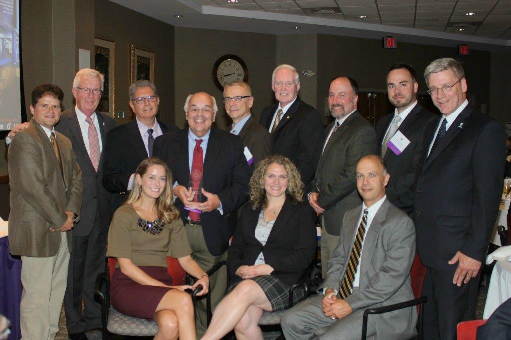 The University of Scranton recognized Hemmler + Camayd Architects as its 2015 Business Partner of the Year. Pictured at the 10th annual awards dinner are, seated from left: representing Hemmler + Camayd Angela Kiesinger, interior design, Laura Gillette-Mills, partner, and Ken Ruby, partner. Standing are: Gerry Zaboski, vice provost for enrollment management and external affairs at the University; Gary Olsen, vice president for University advancement; Hemmler + Camayd partners Alex Camayd, David Hemmler and Richard Leonori; James Devers, associate vice president for facilities operations at the University; Tom Gercak, partner, Hemmler + Camayd; Cosmo Lovecchio, project architect, Hemmler + Camayd; and Edward J. Steinmetz, senior vice president for finance and administration at the University.  
